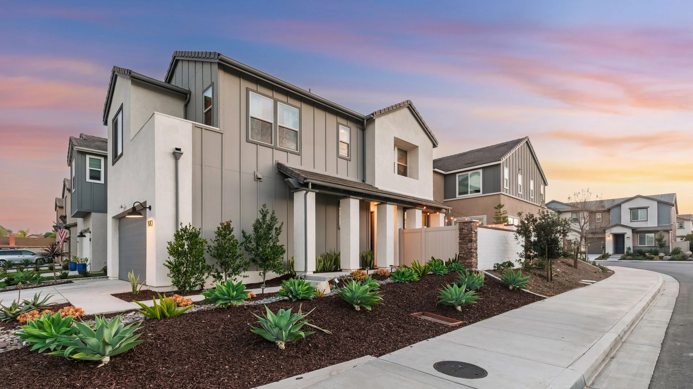 A modern San Diego home at sunset, agave and drought-tolerant landscaping out front